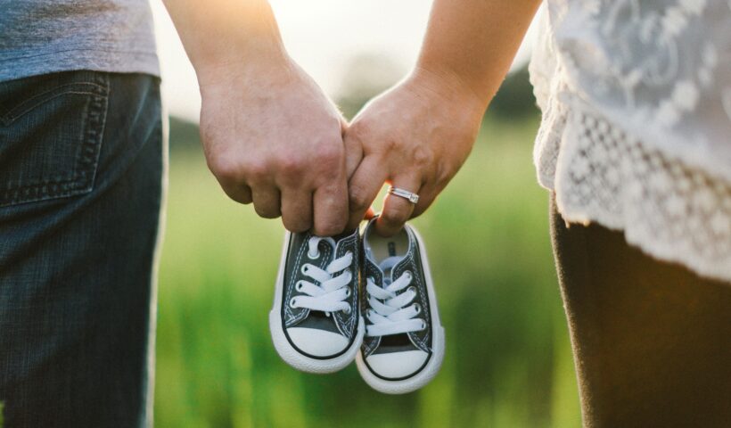 https://unsplash.com/photos/woman-and-man-holding-black-crib-shoes-standing-near-green-grass-during-daytime-7tGqLzHcjZ8